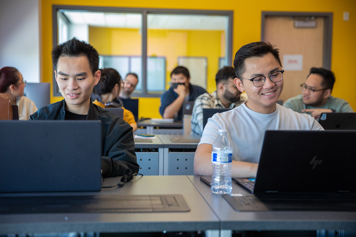 Students looking at laptops