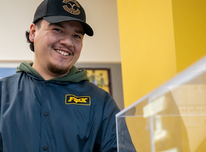 Latino Mechatronics student poses for picture in lab.