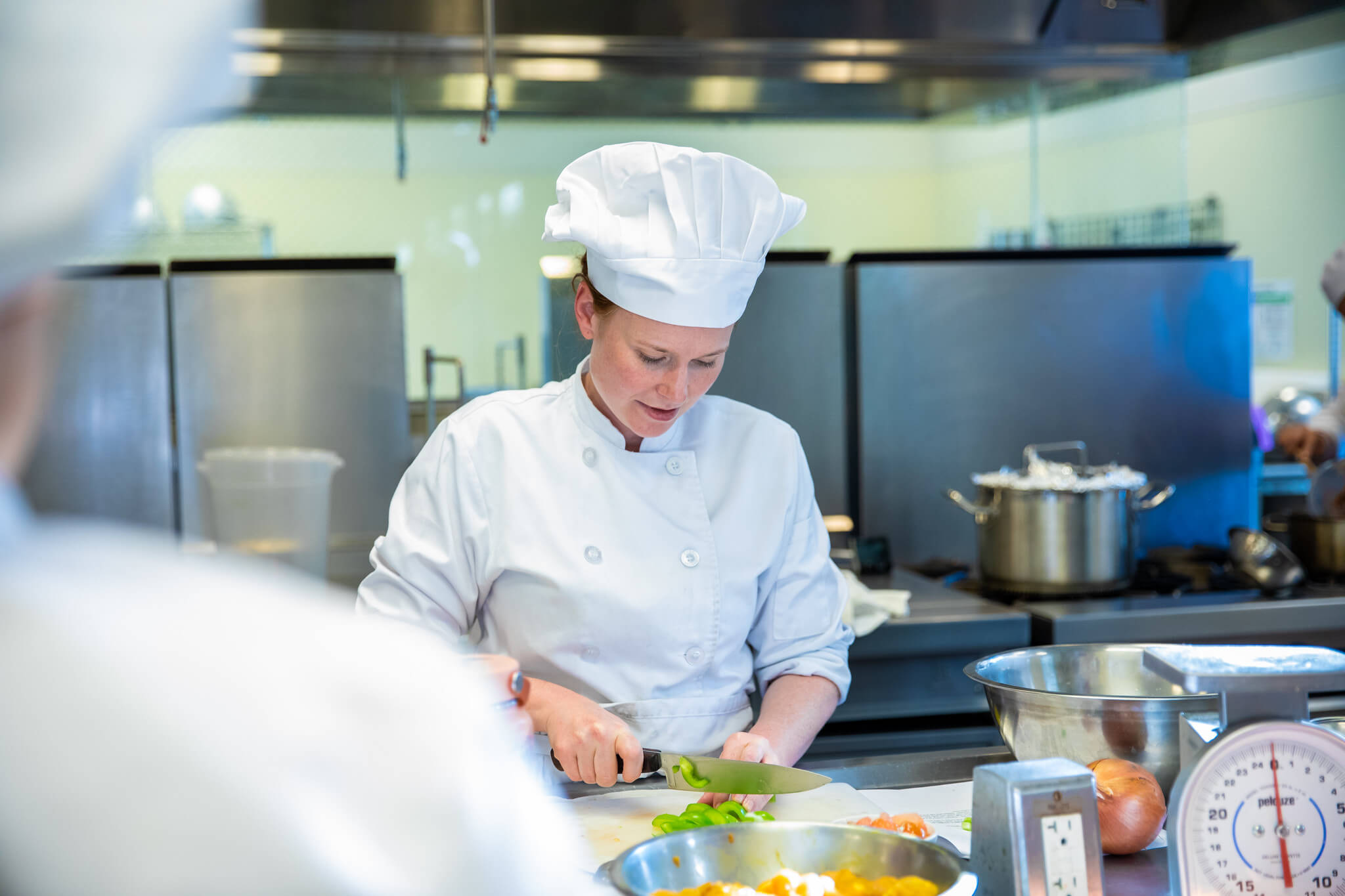 Hospitality Management student slicing vegetables