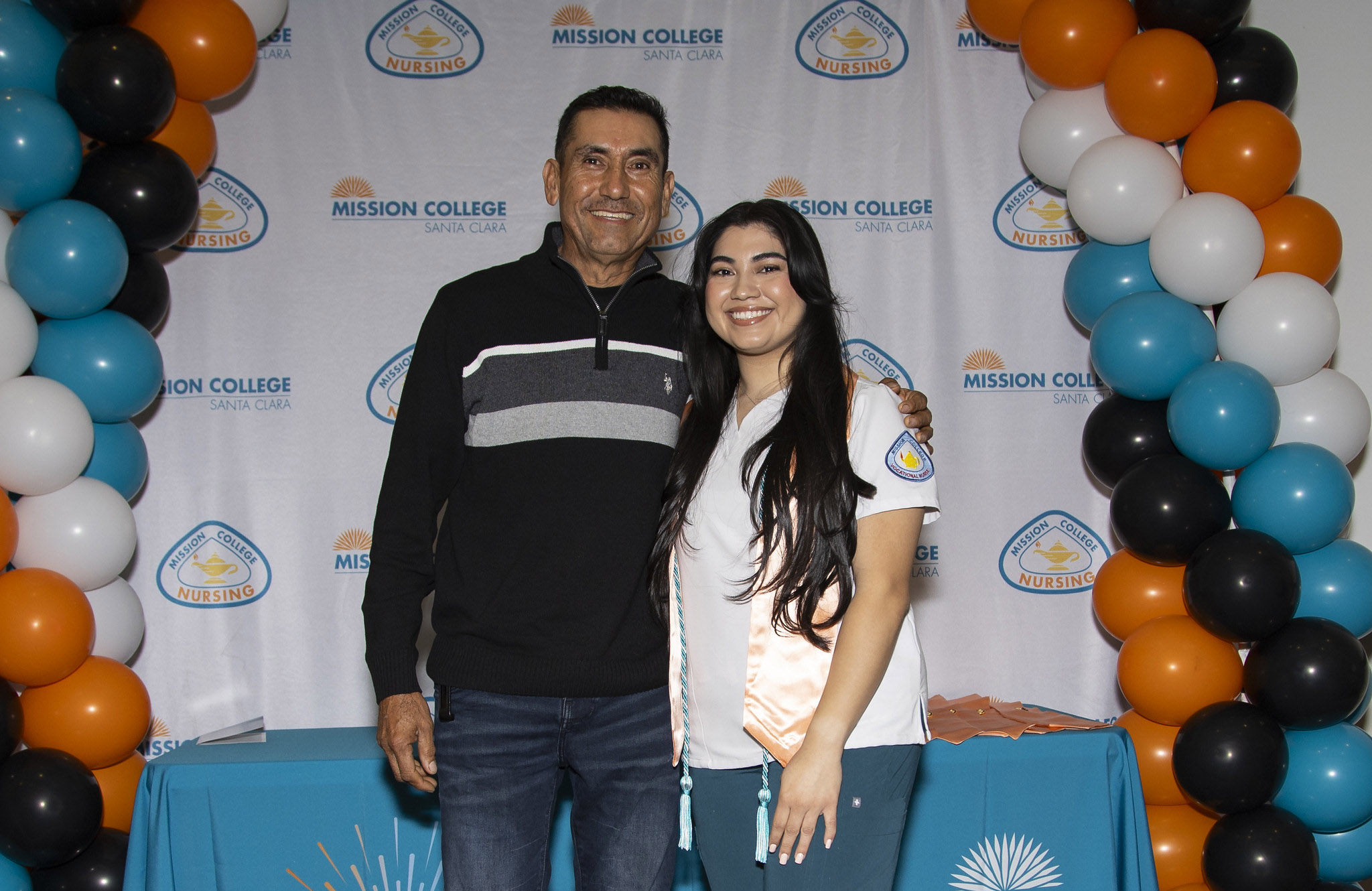 Vocational nursing graduate posing for picture with another person