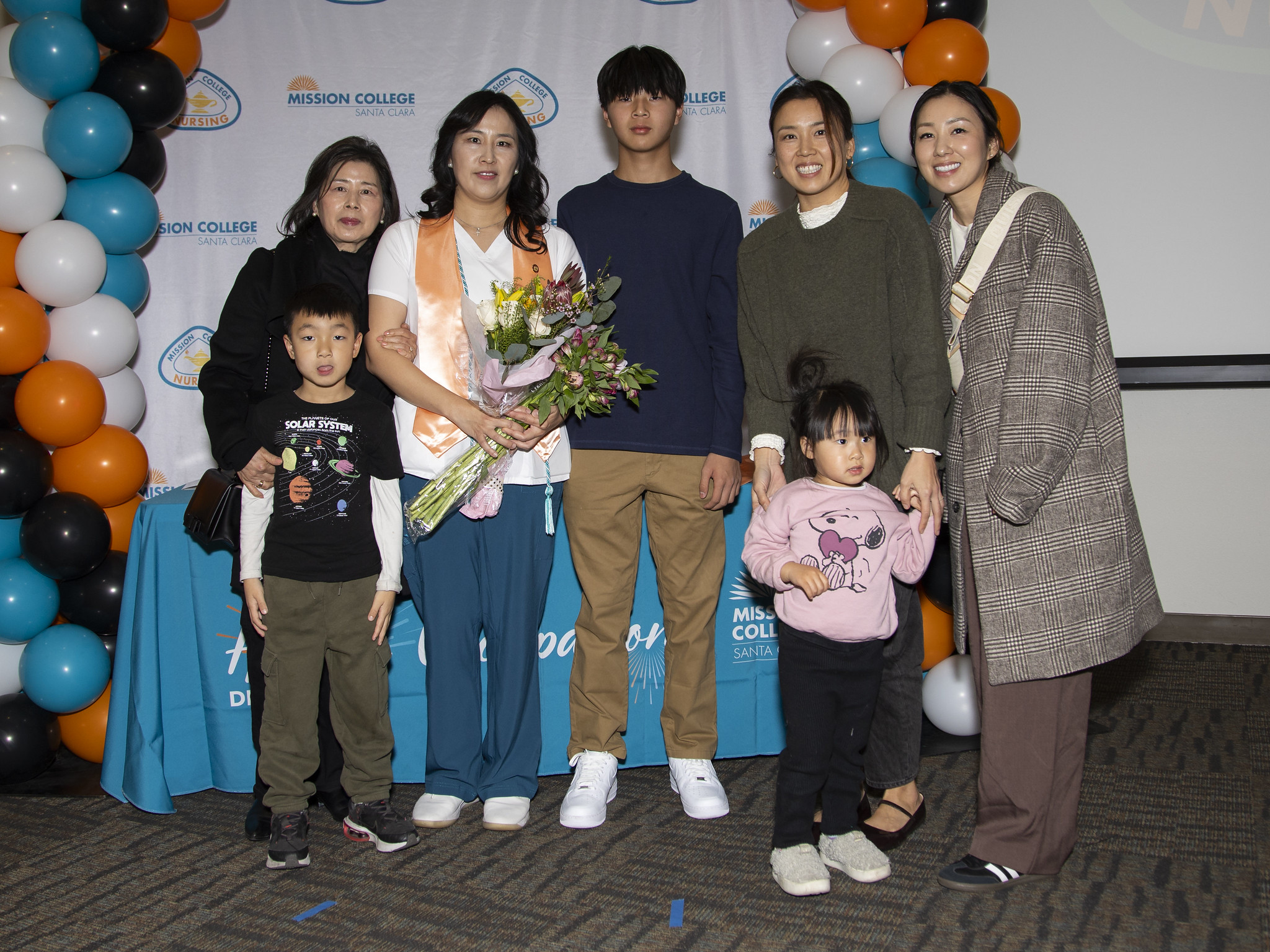 Vocational nursing graduate posing for picture with others
