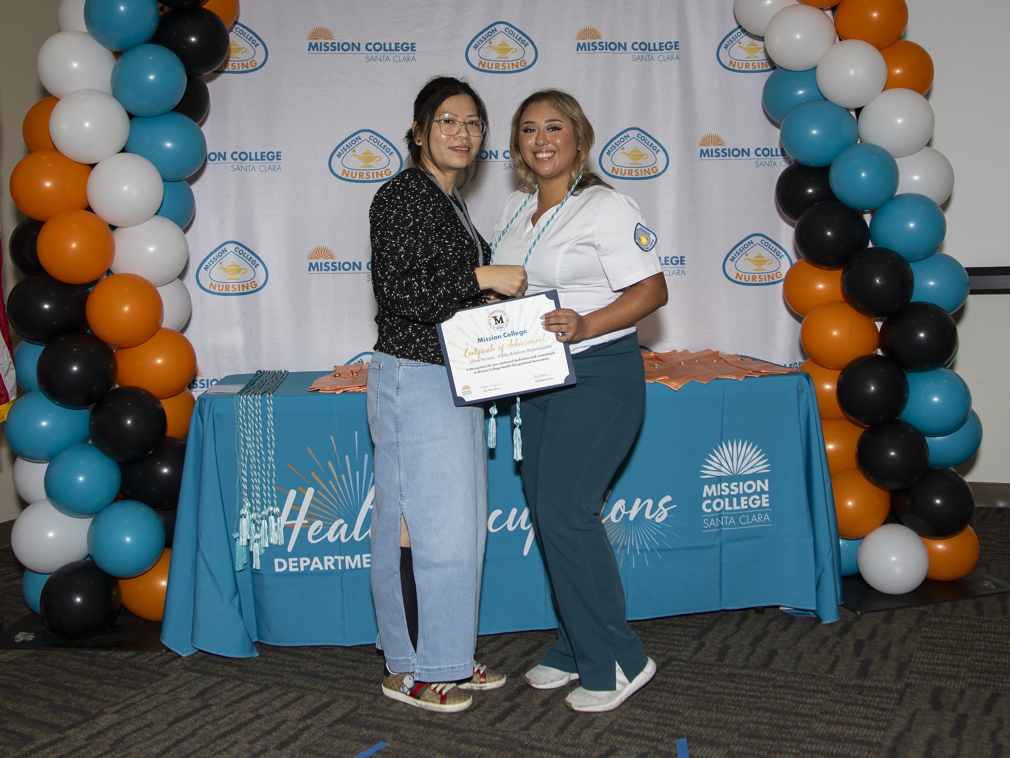 Vocational nursing graduate posing for picture with another person