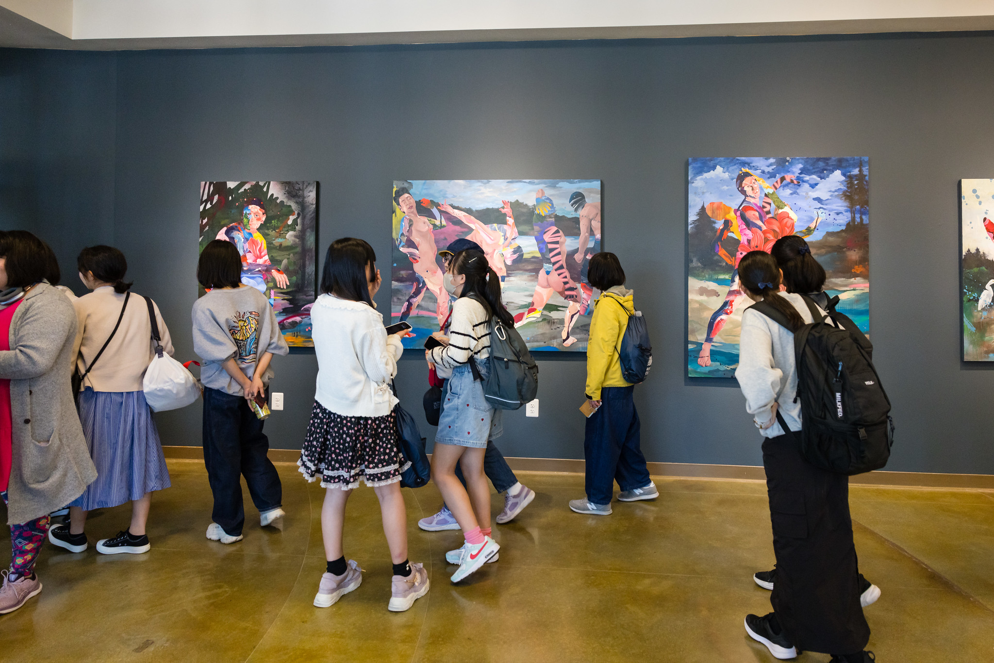 Students walking through art gallery