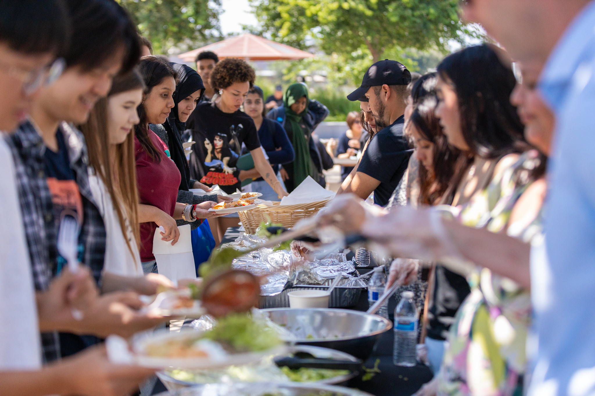 Students dishing themselves out food at basic needs fair