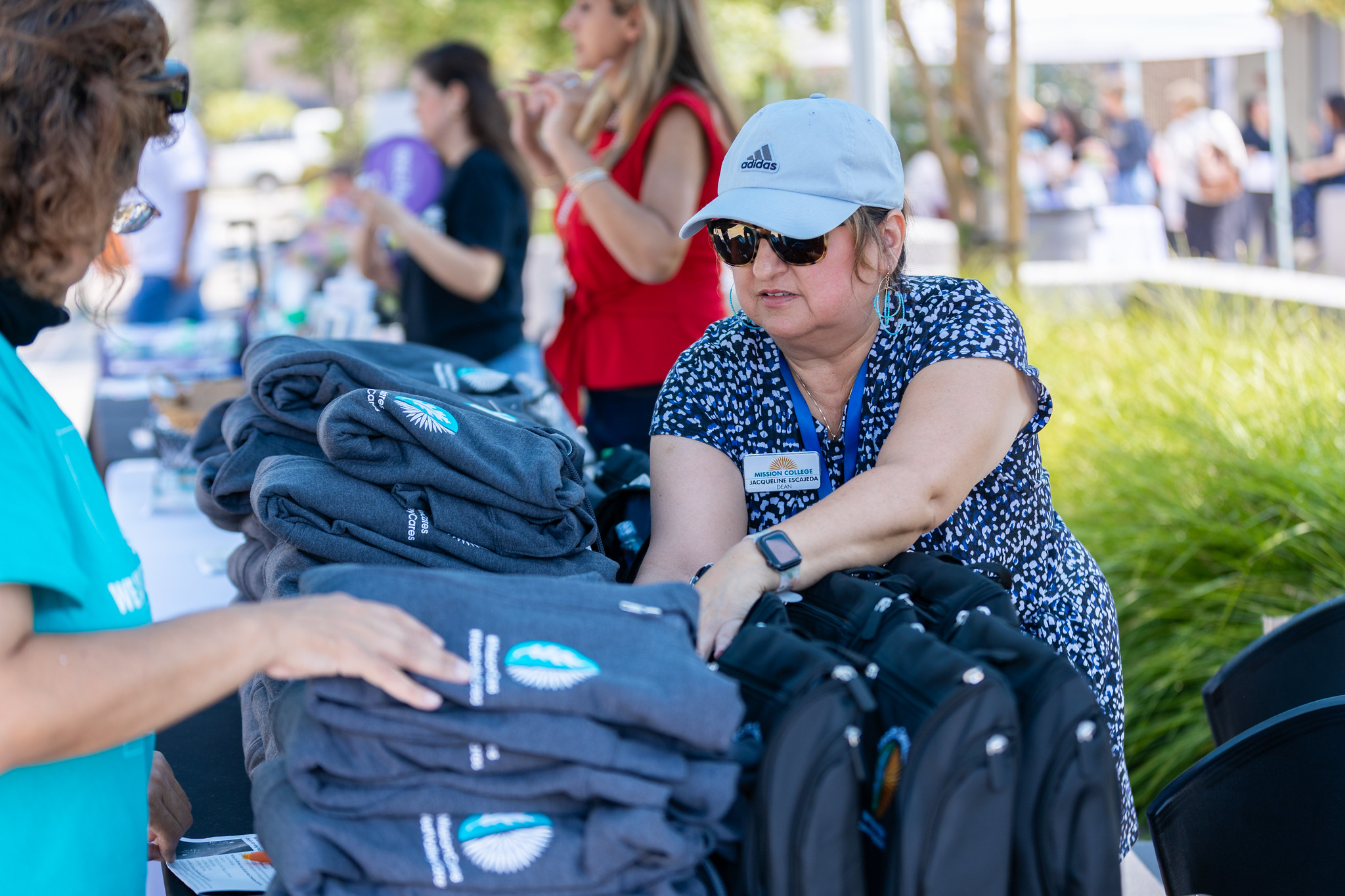 Person at basic needs hair handing out clothing