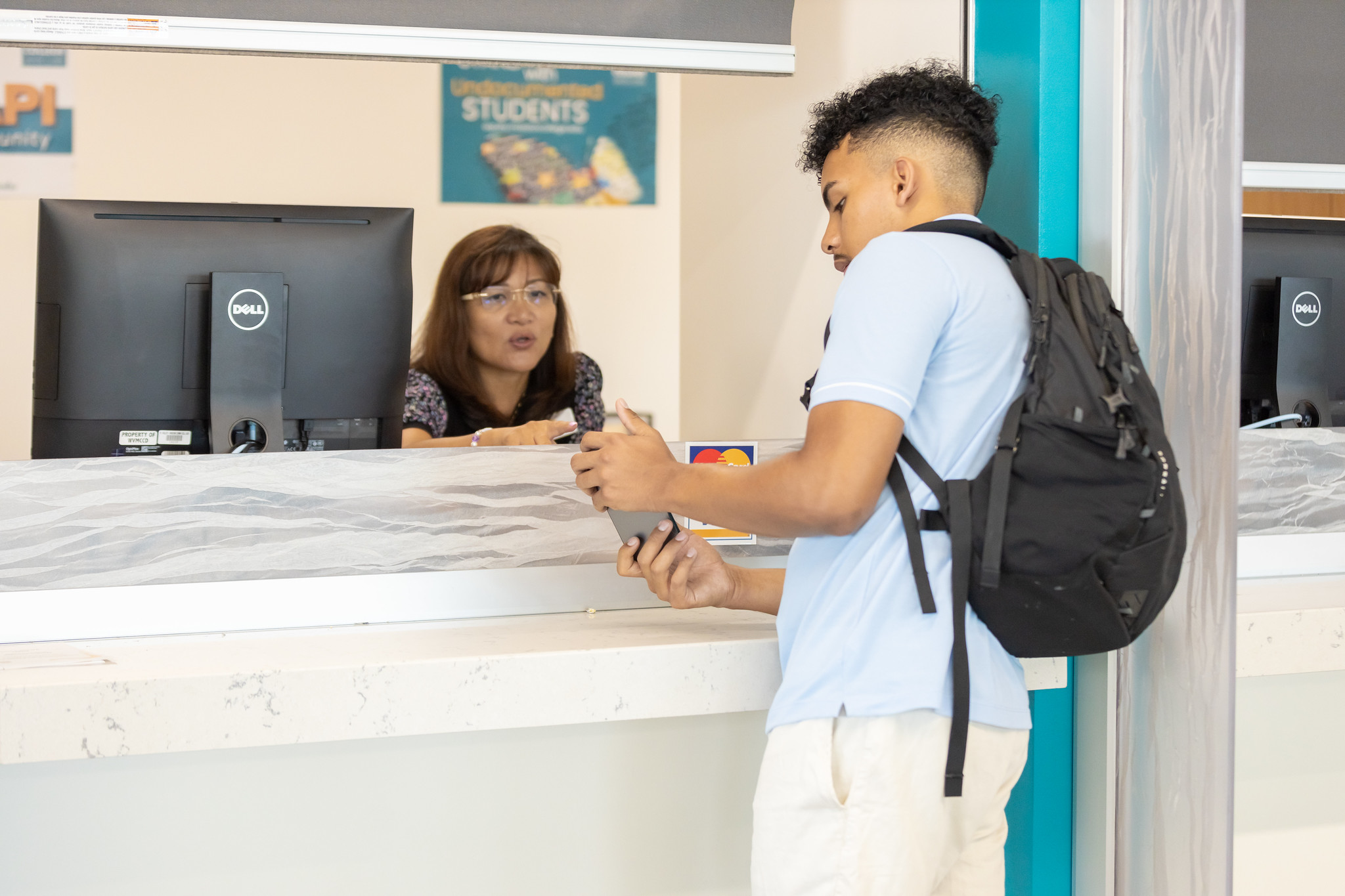 Student talking to staff member