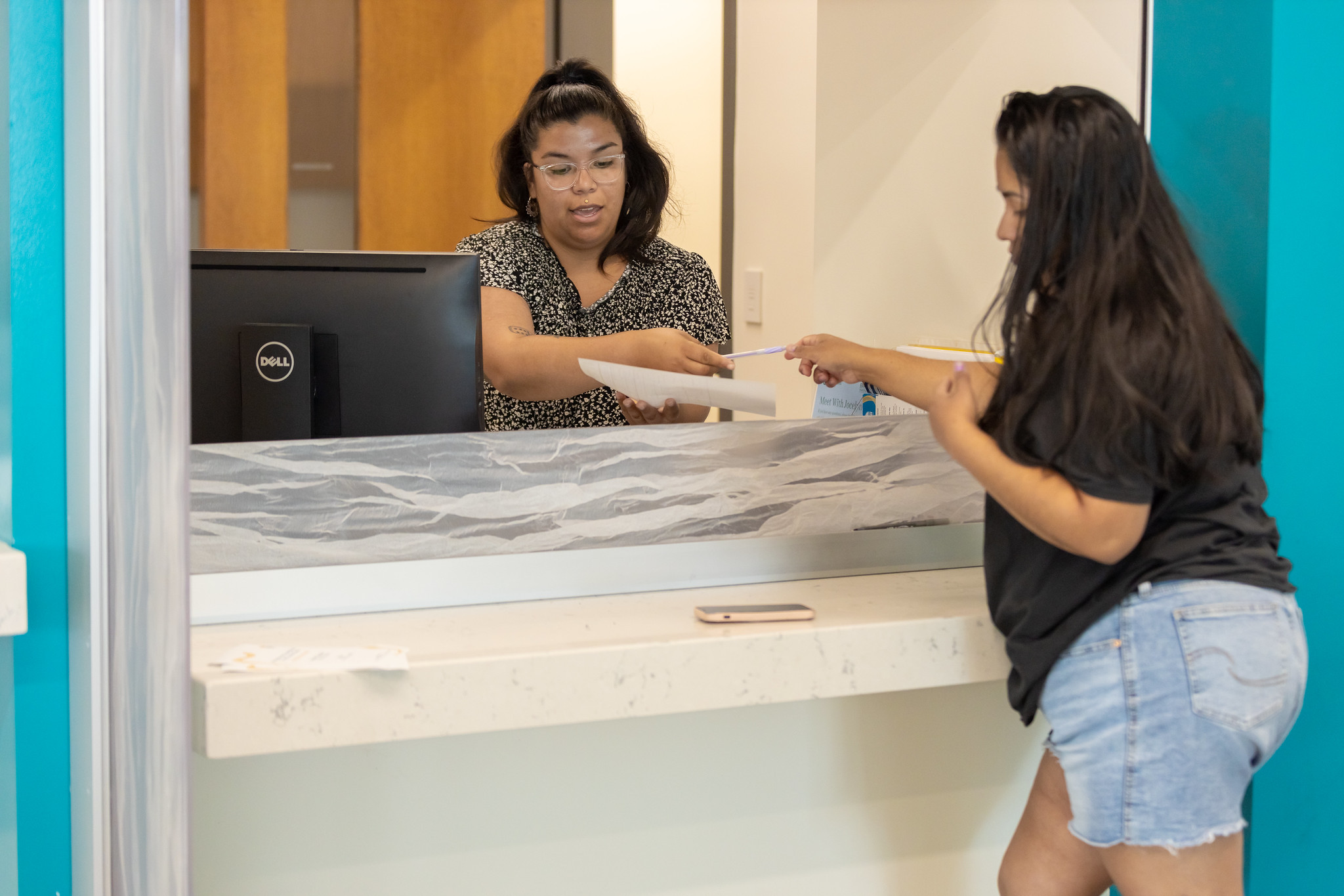 Student talking to staff member