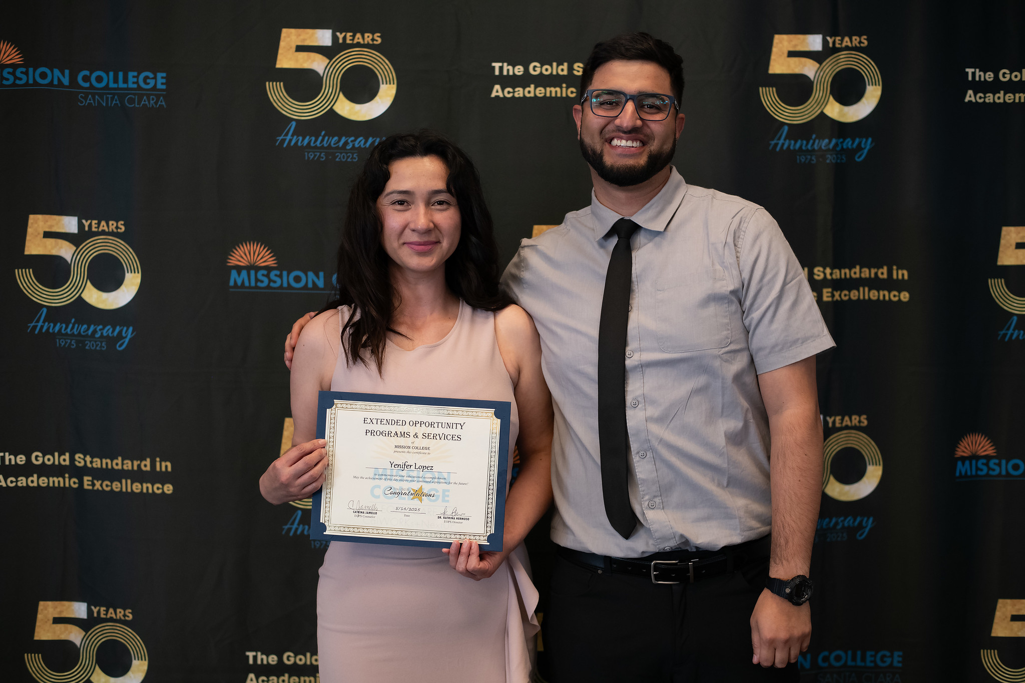 Student with counselor holding a certificate