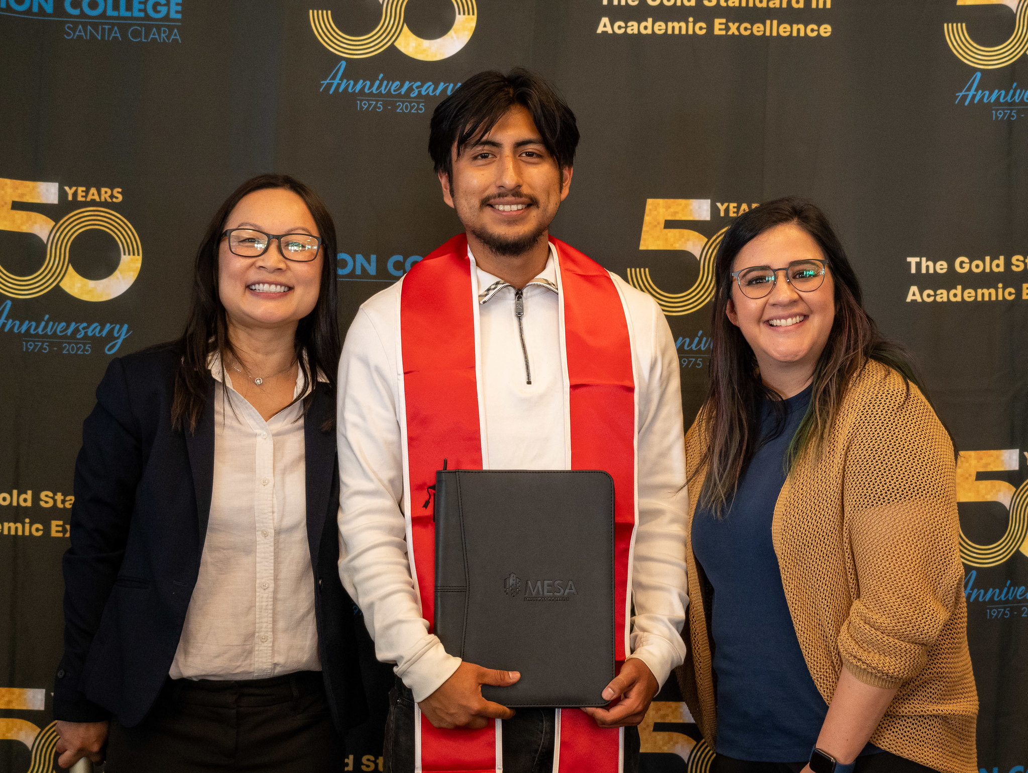 Student with counselors holding a certificate