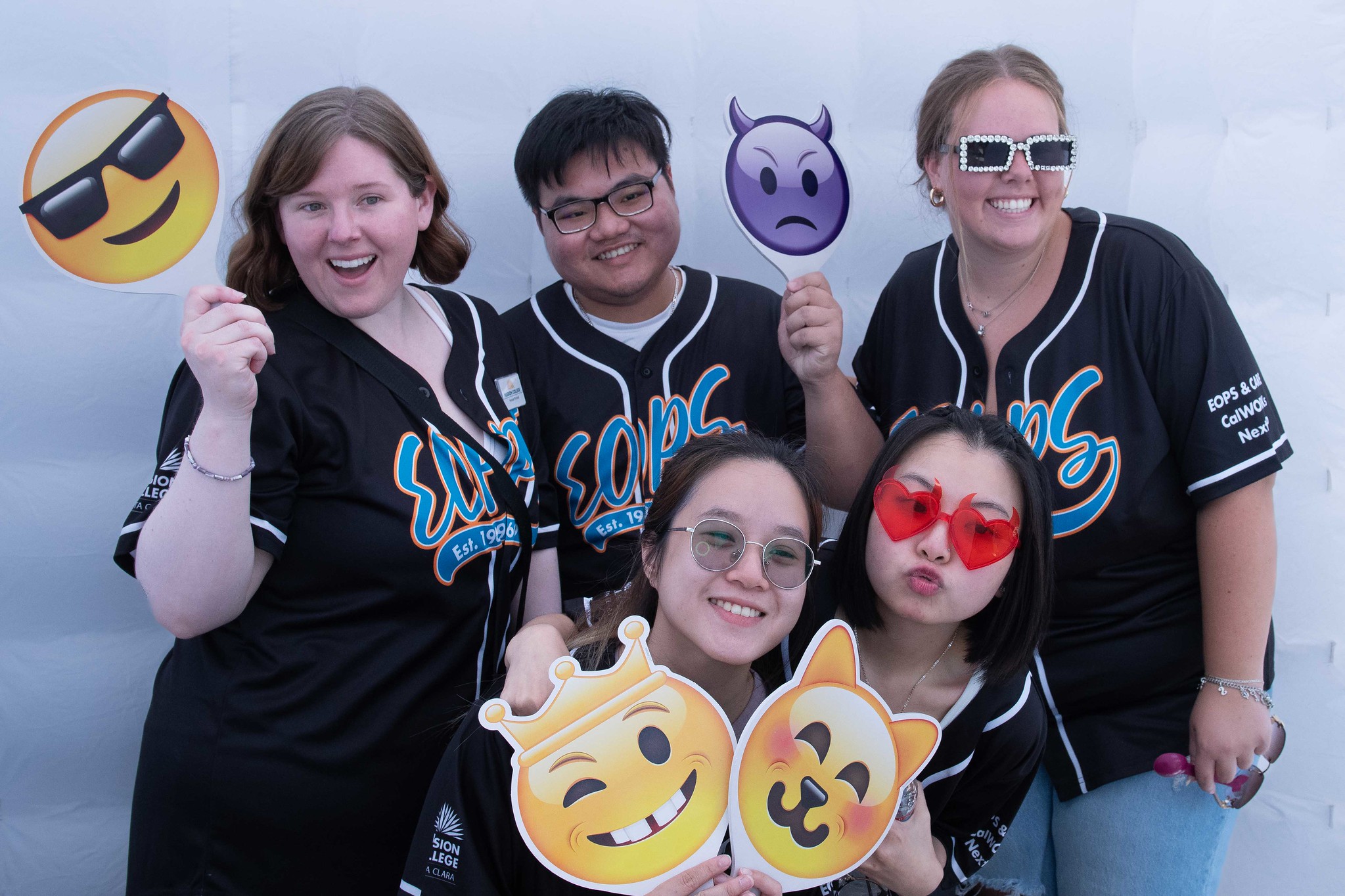 EOPS members holding emoji selfie props posing for pictures