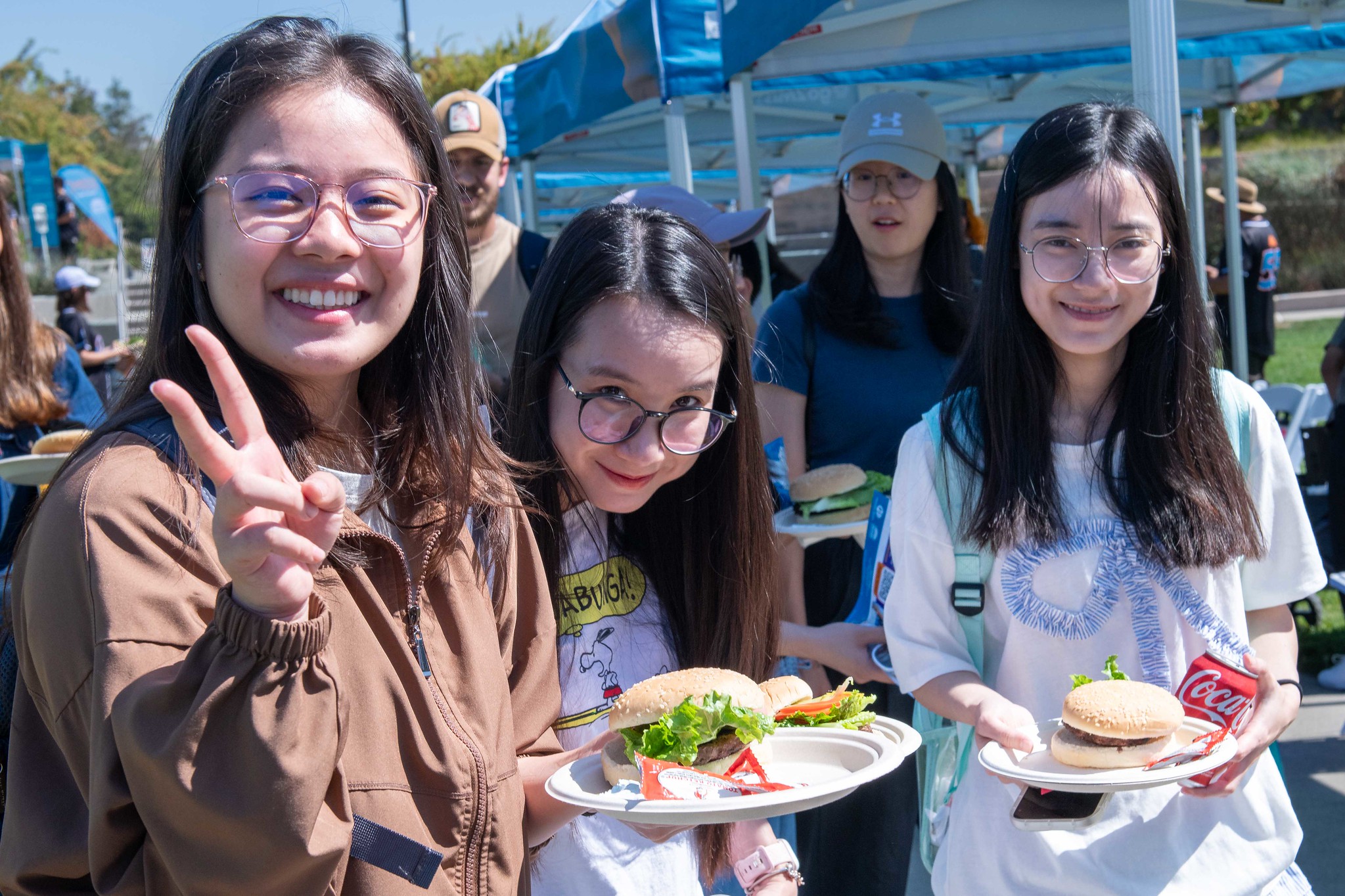 Mission College students getting food and posing for picture