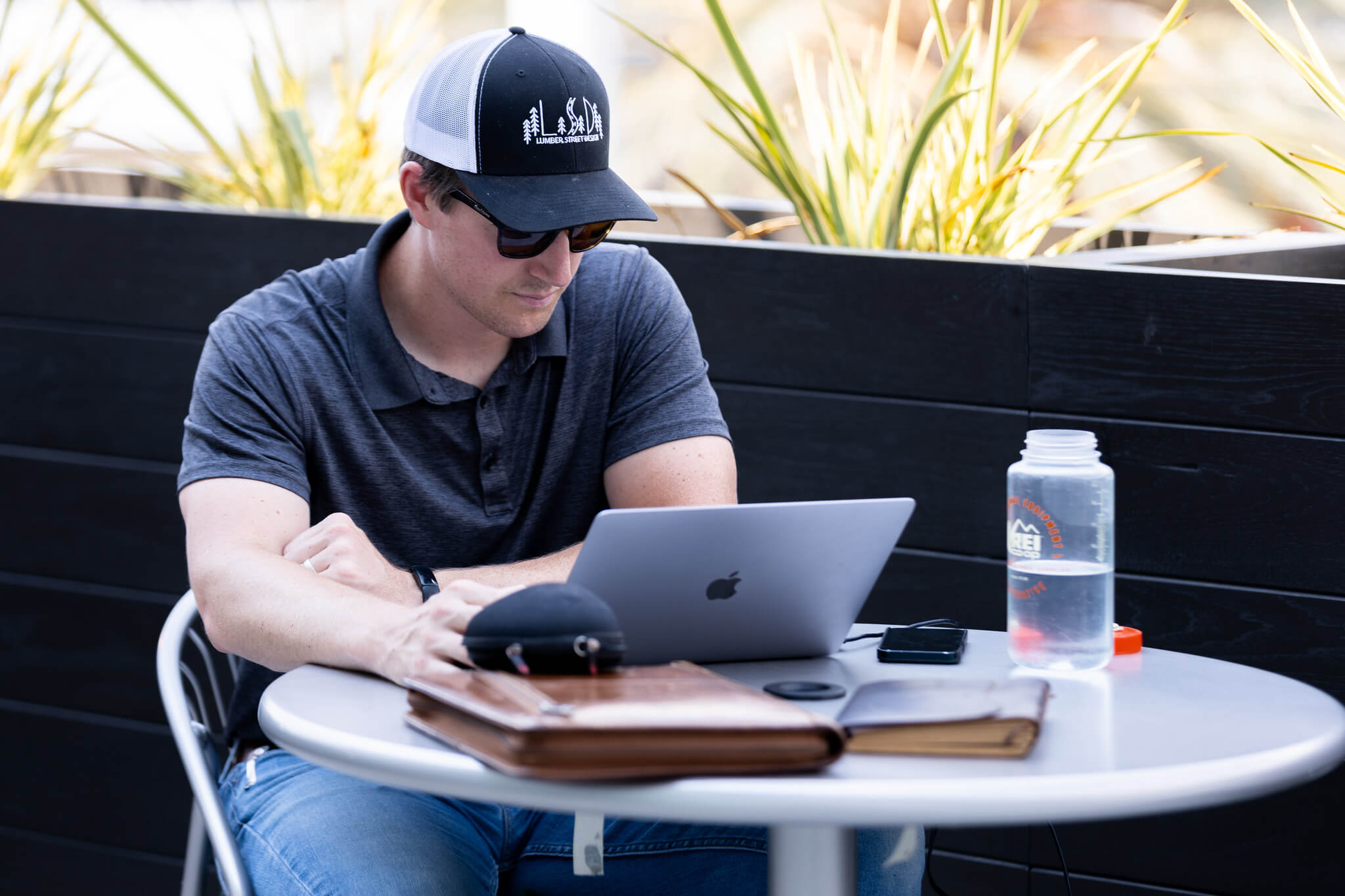 Mission College student sitting outside on his laptop