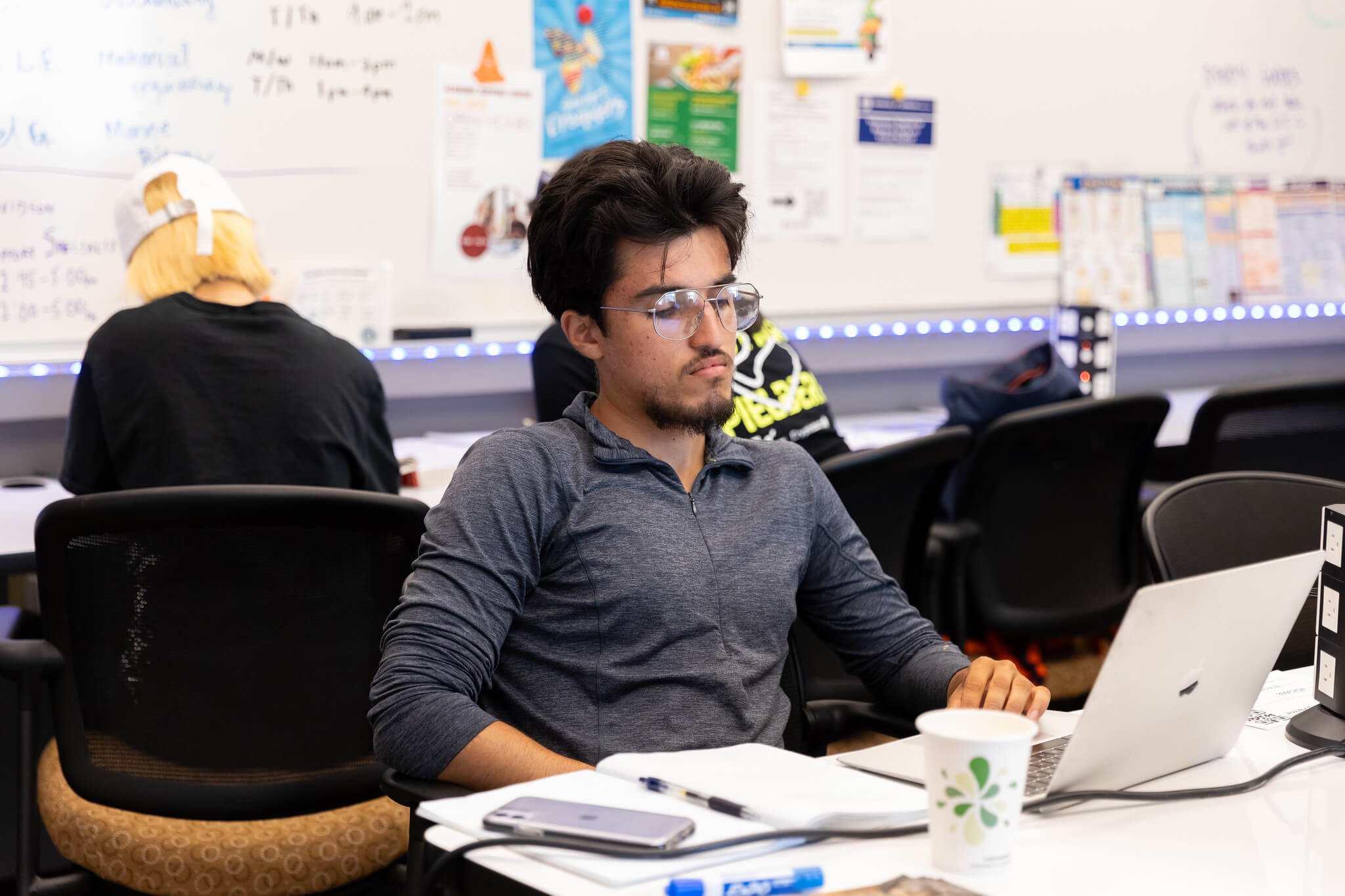 Mission College student in class on his laptop 