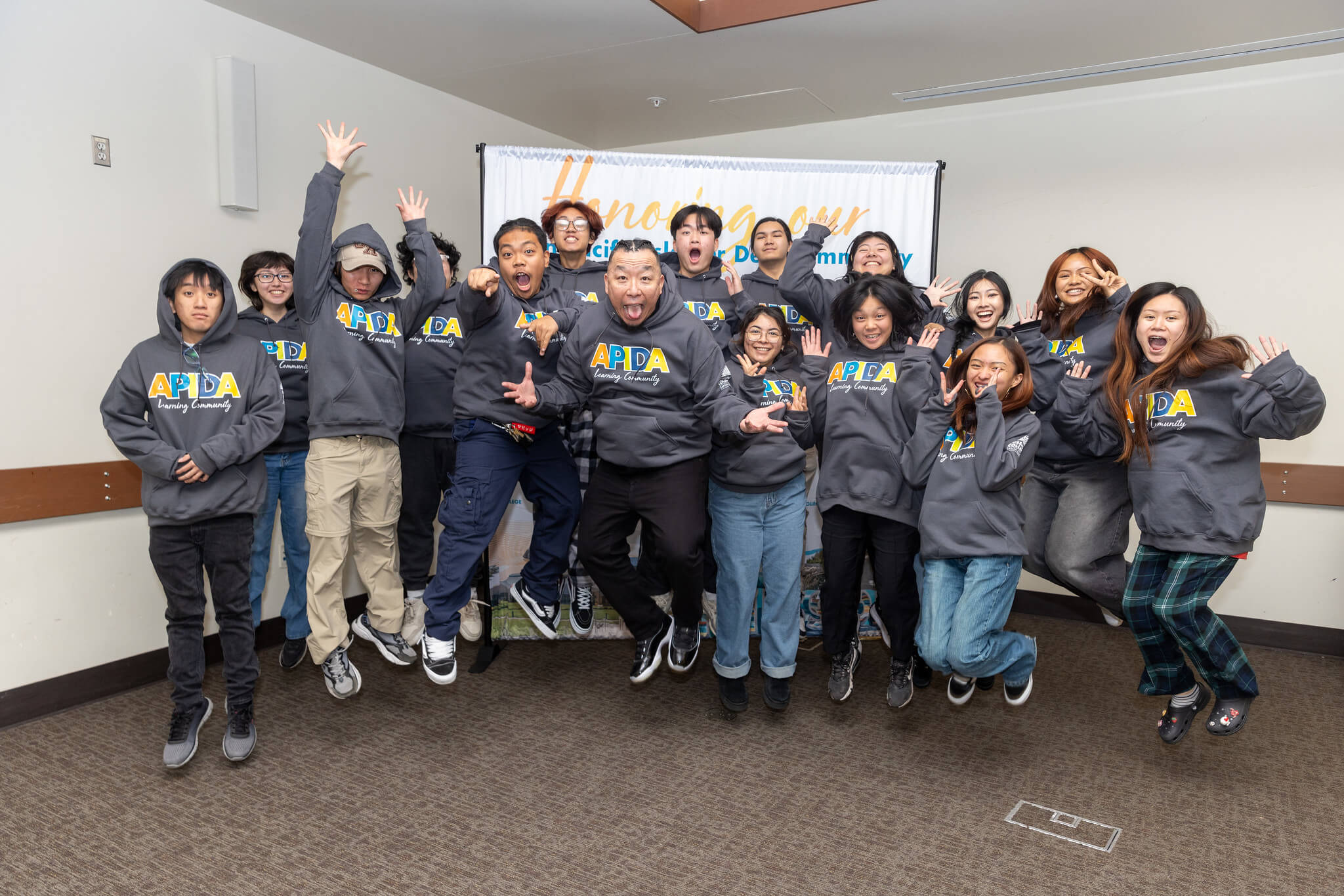 Students posing for pictures and jumping