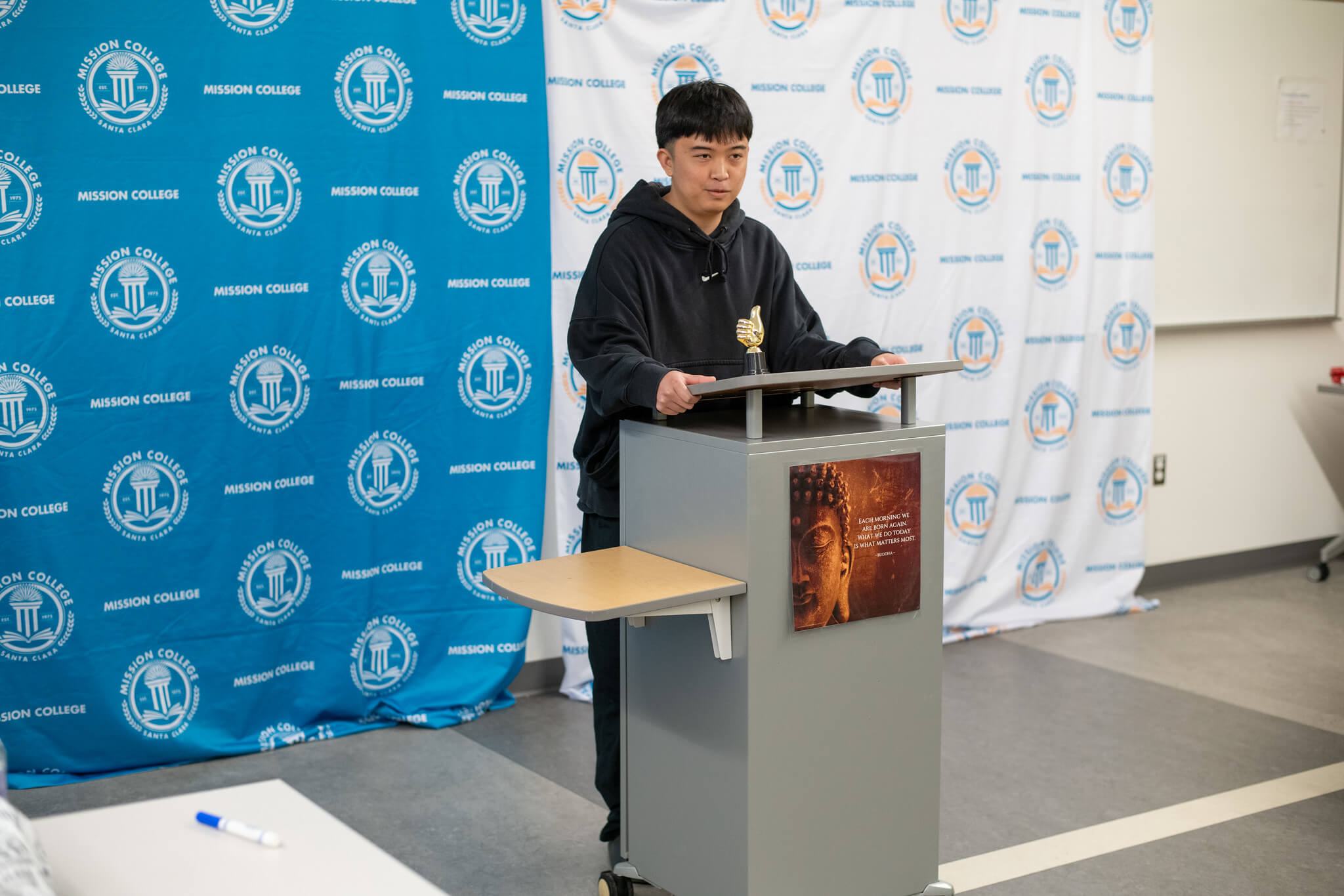 Mission College student speaking at a podium