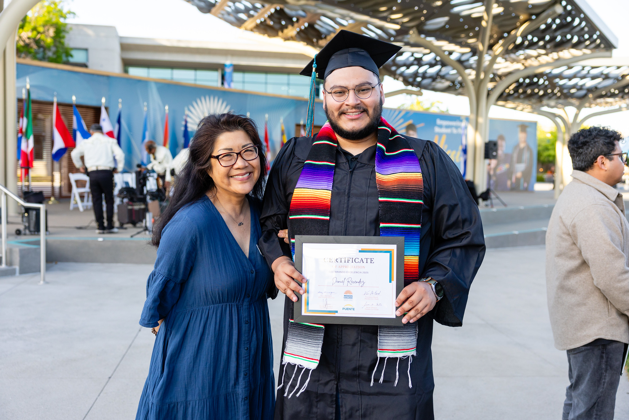 Student with counselor holding a certificate