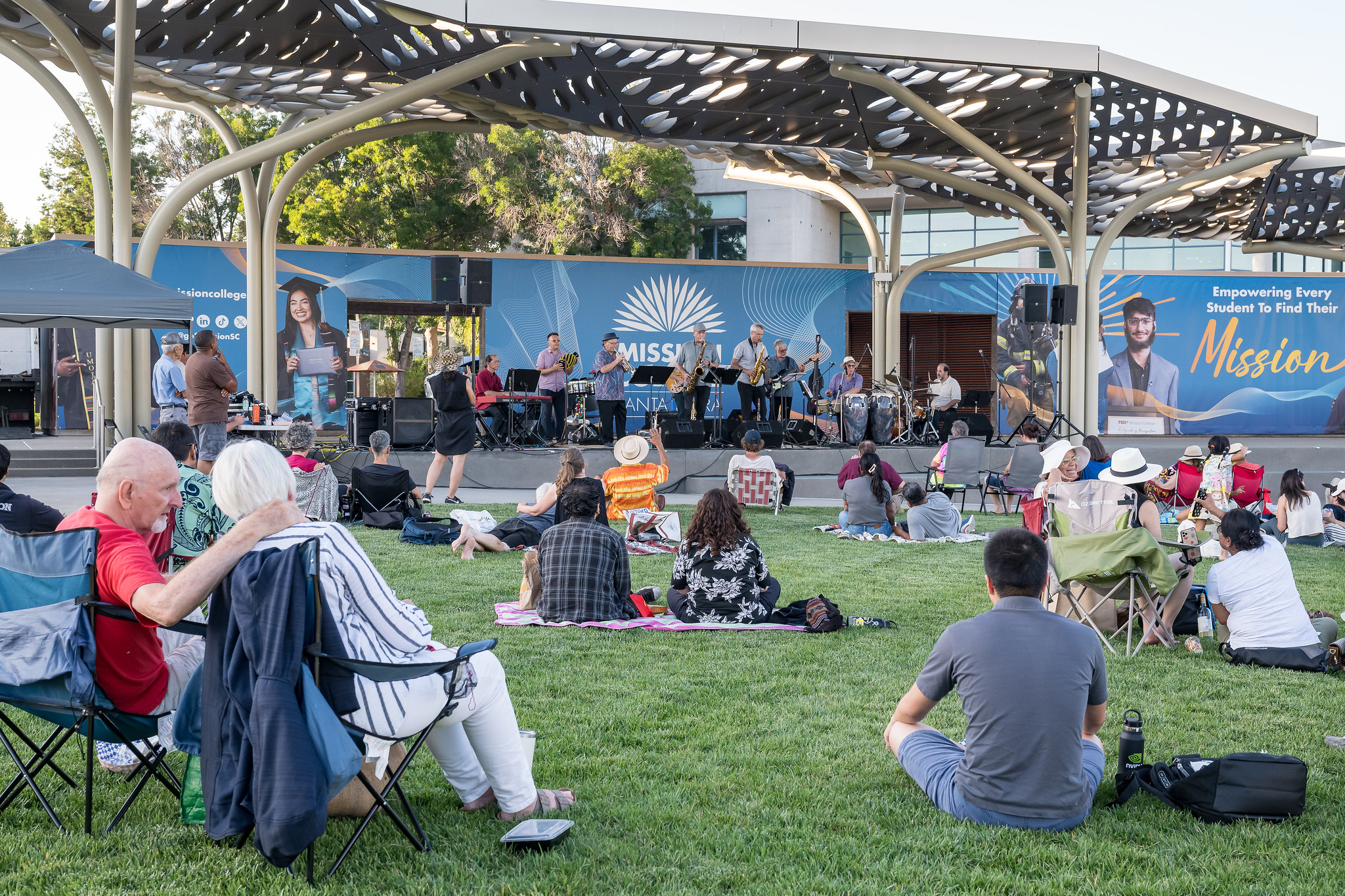 People on lawn watching concert