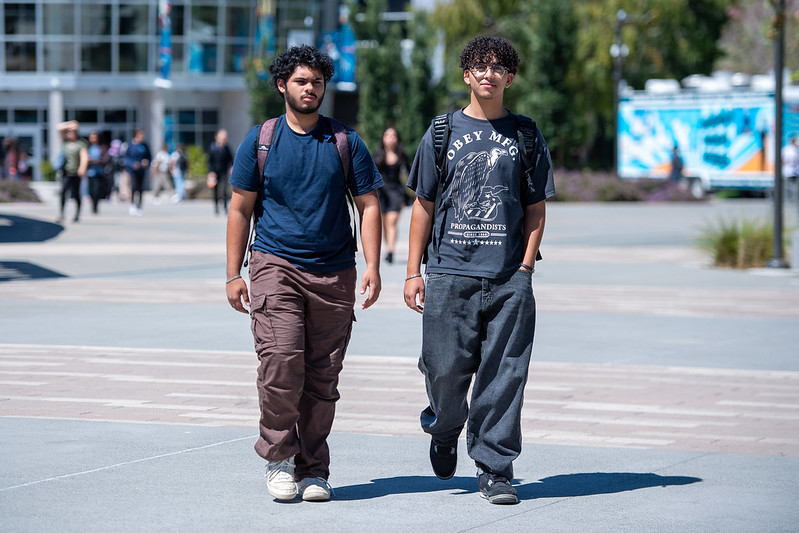 Two students walking on campus