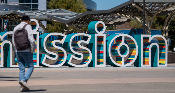 Student walking near sign