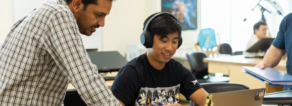 Teacher working with student