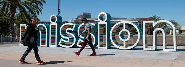 Students walking near sign