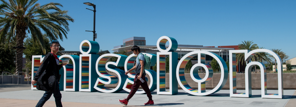 Students walking near sign
