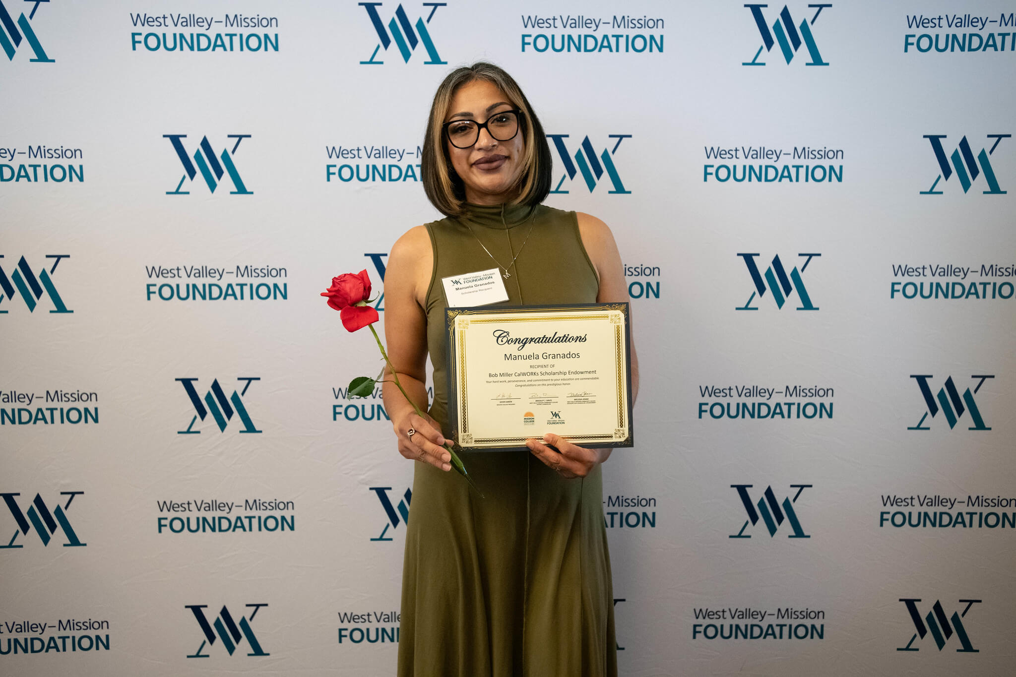 Female student holding certificate