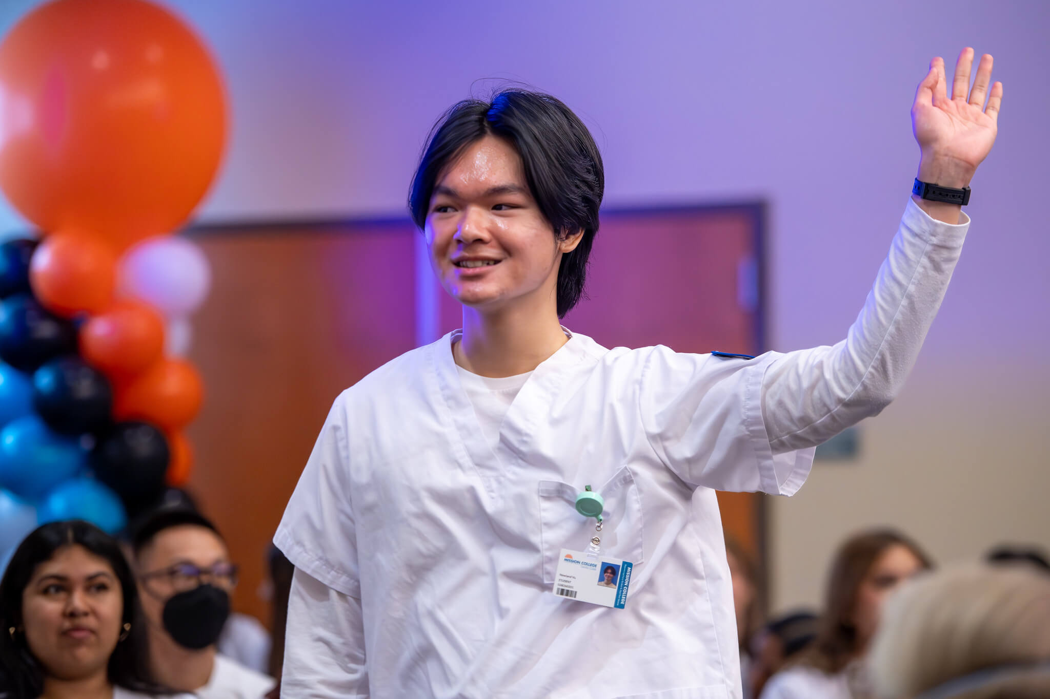 Student walking and waving