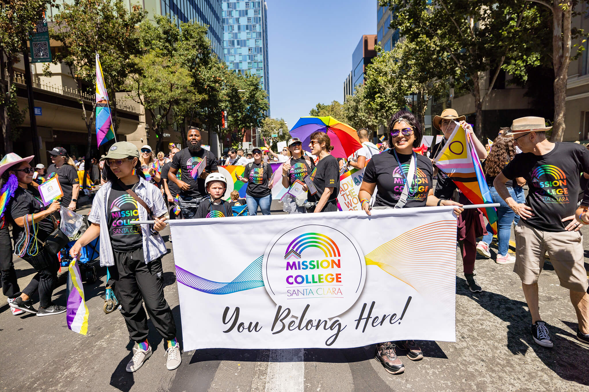 Mission College participation in Pride Day Parade, with Seher Awan holding one side of the banner
