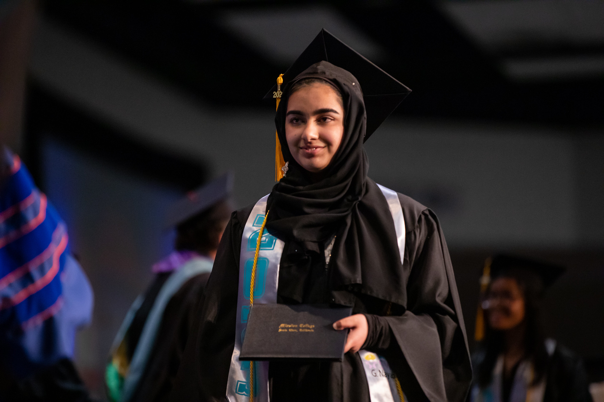 Mission College graduate walking