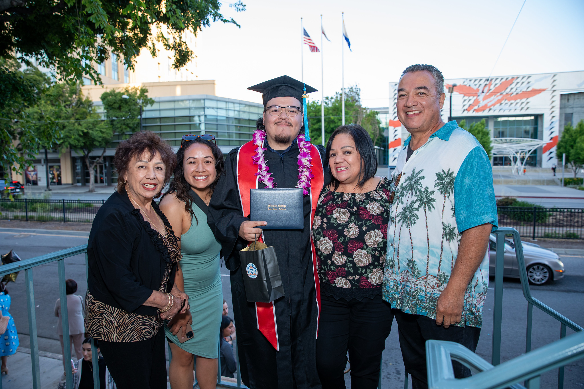 Mission College graduate with family