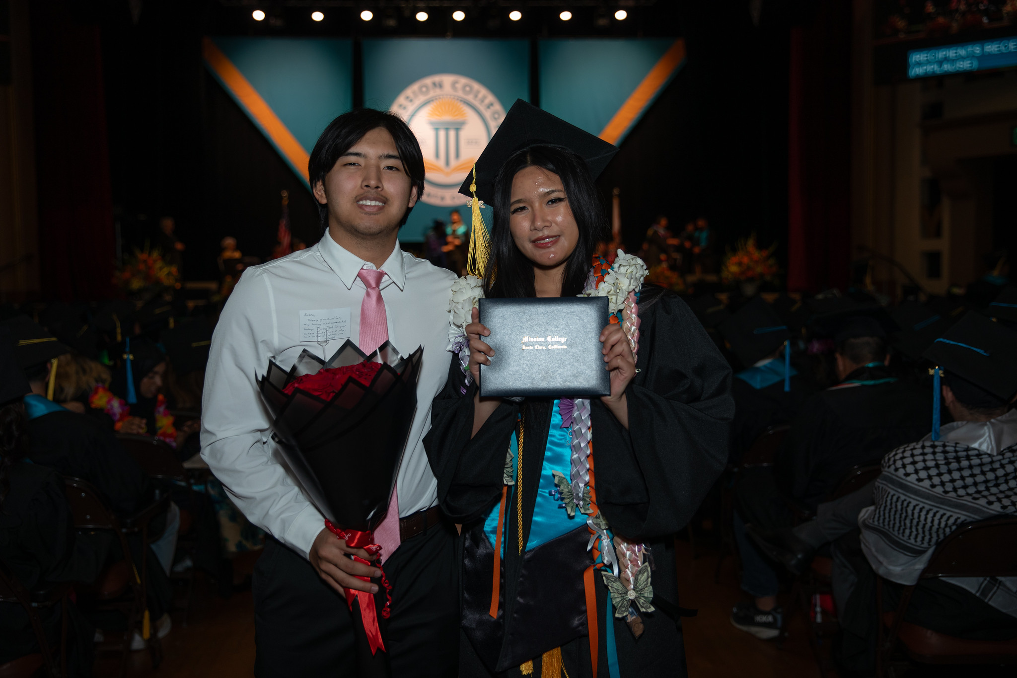 Mission College graduate with family