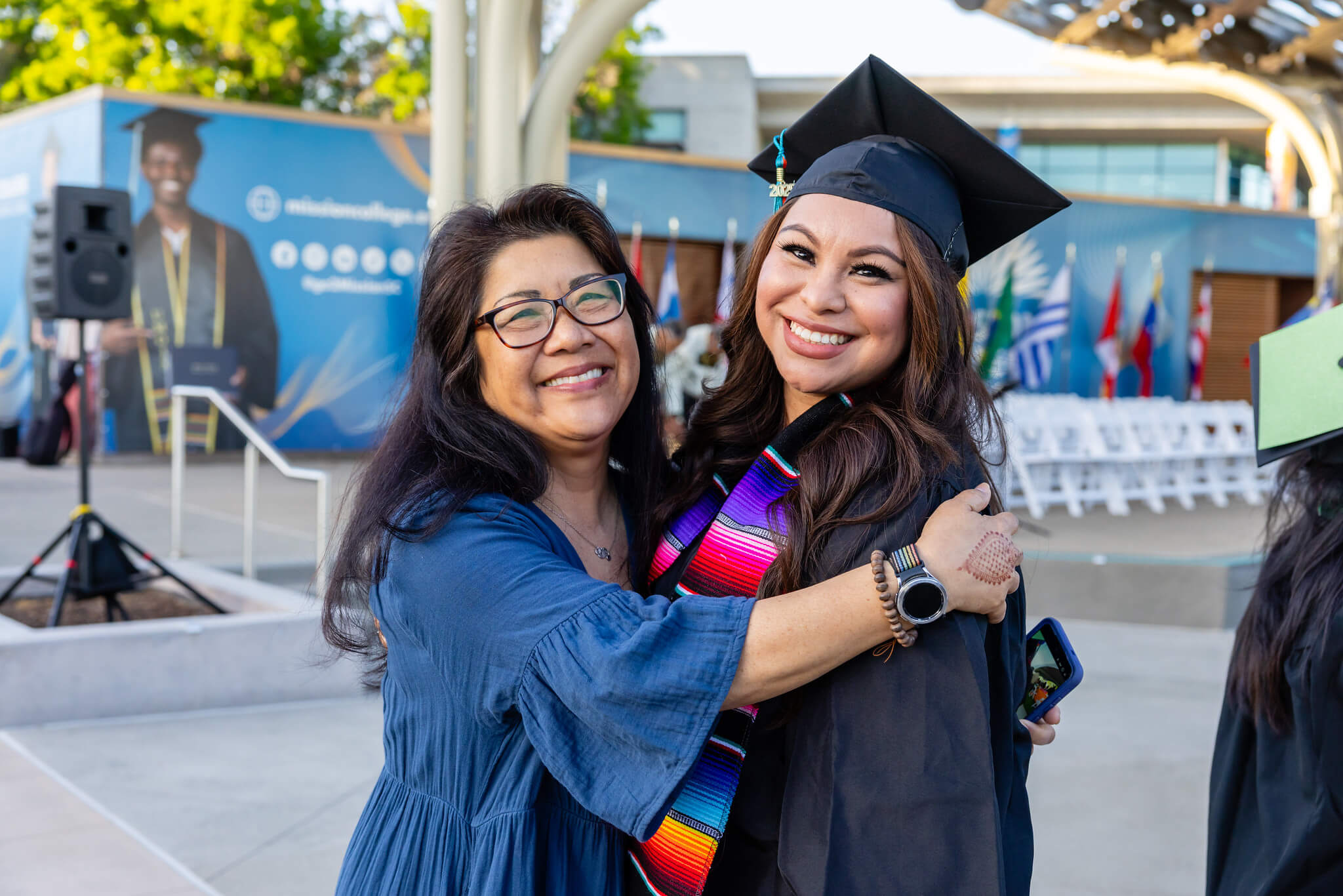 Graduate smiling with another person