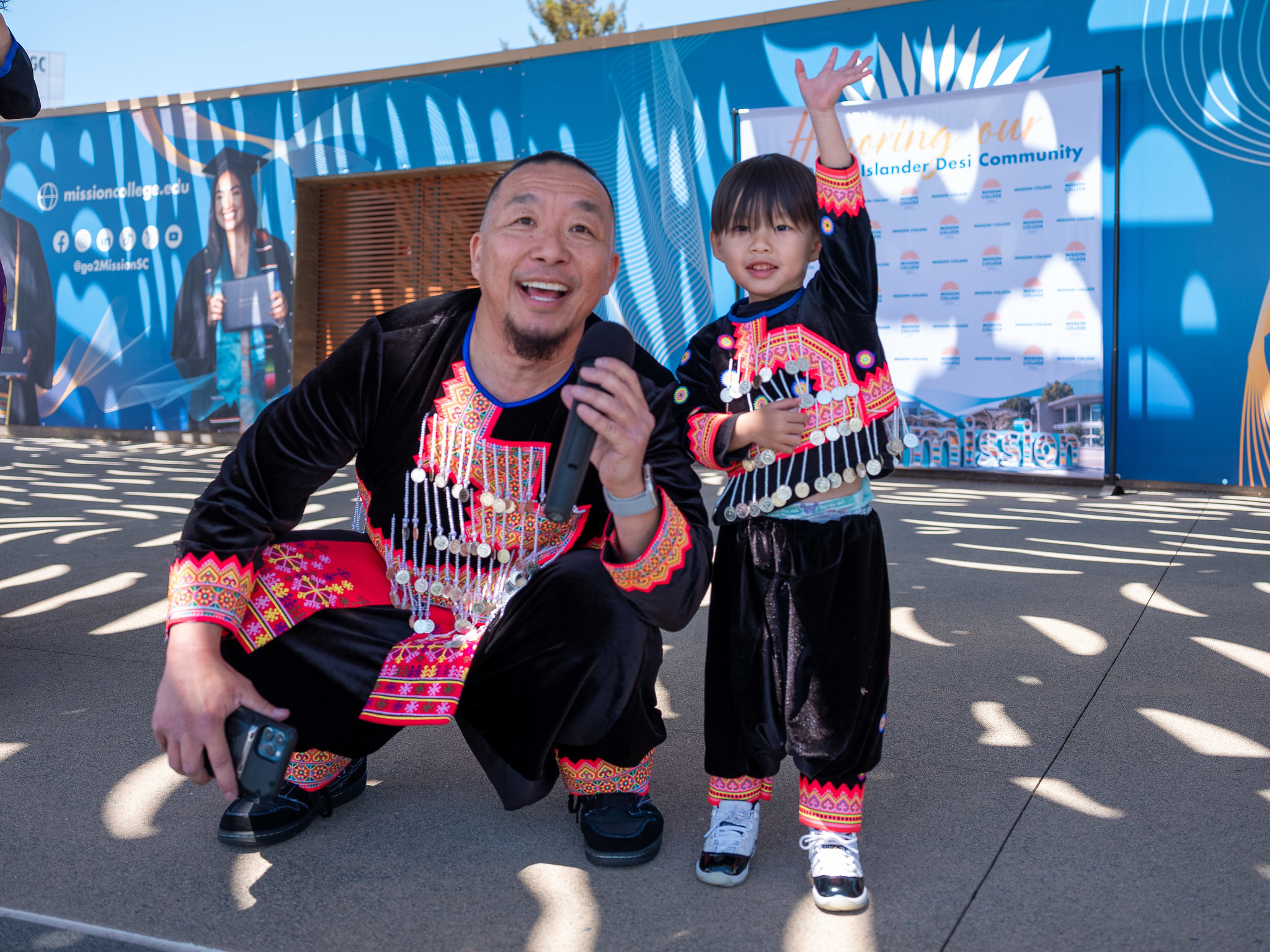APIDA faculty member with child posing for picture