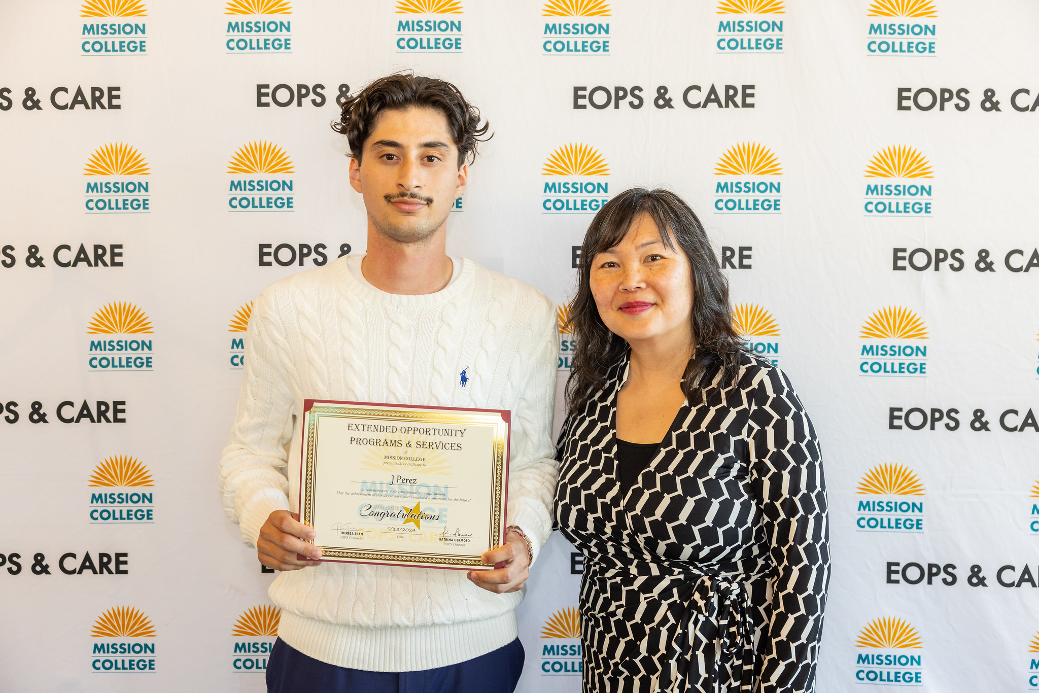 EOPS student posing for picture holding certificate