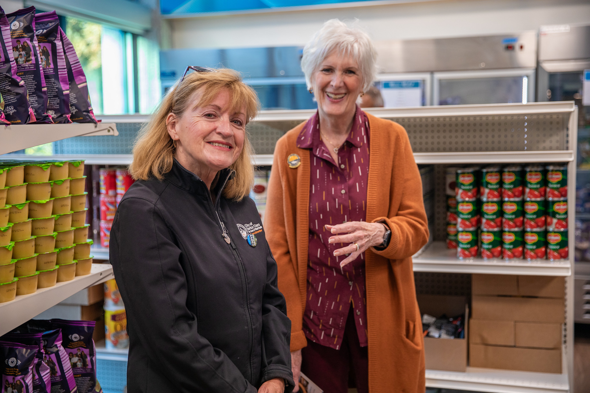 Two people posing for picture in Mission Market