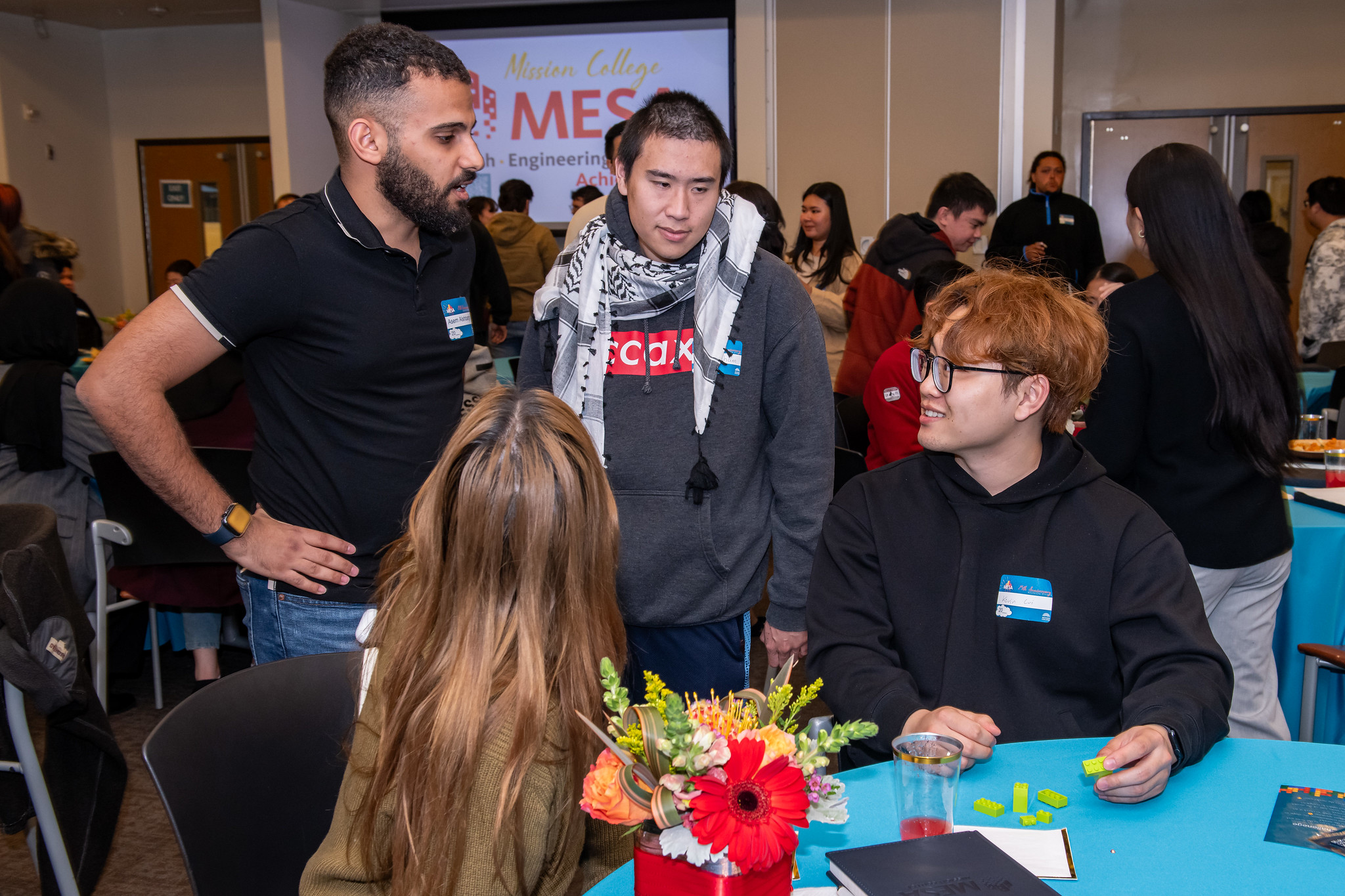 Students talking at table at Mesa anniversary event