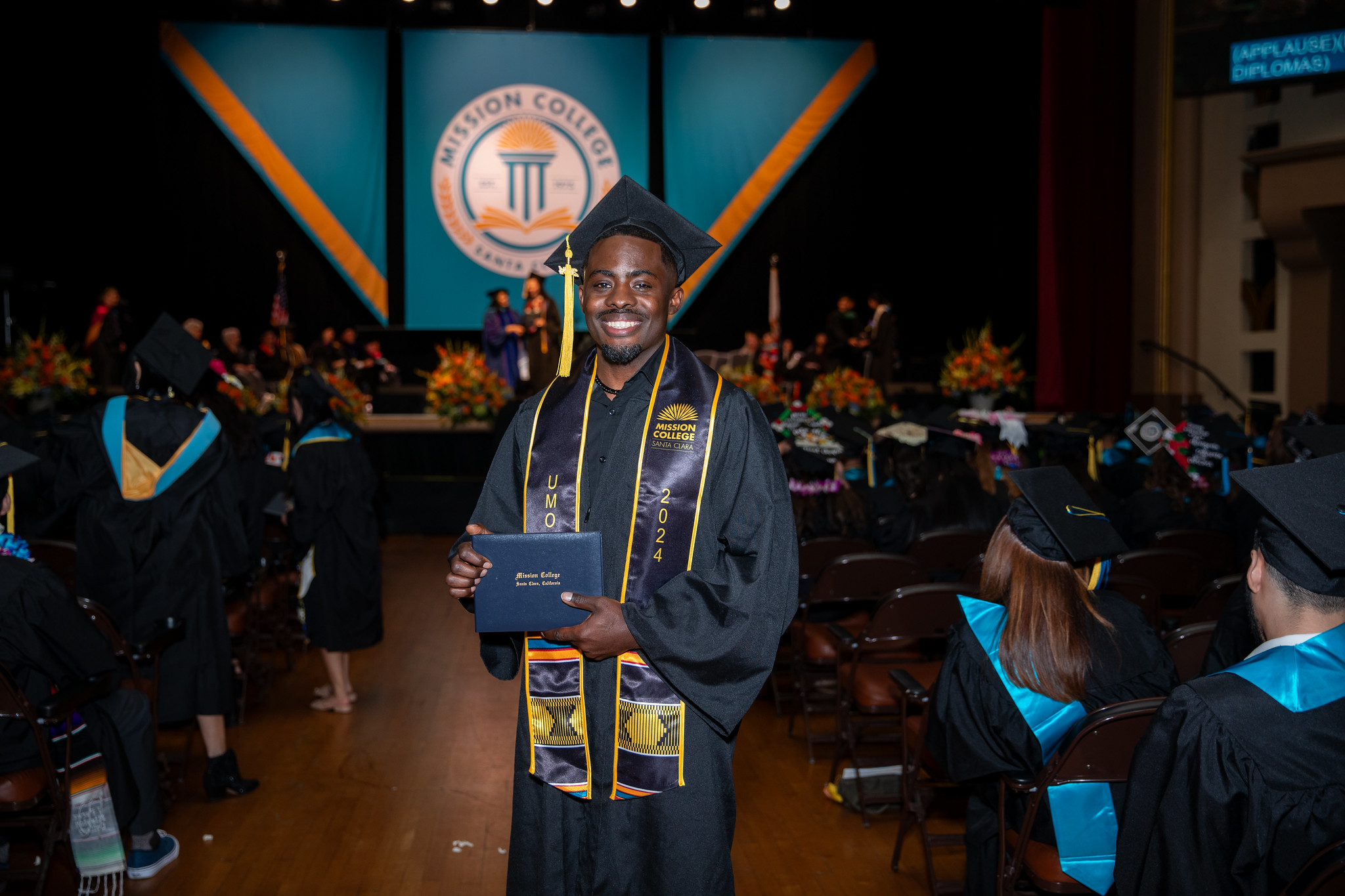 Mission College graduate smiling for picture
