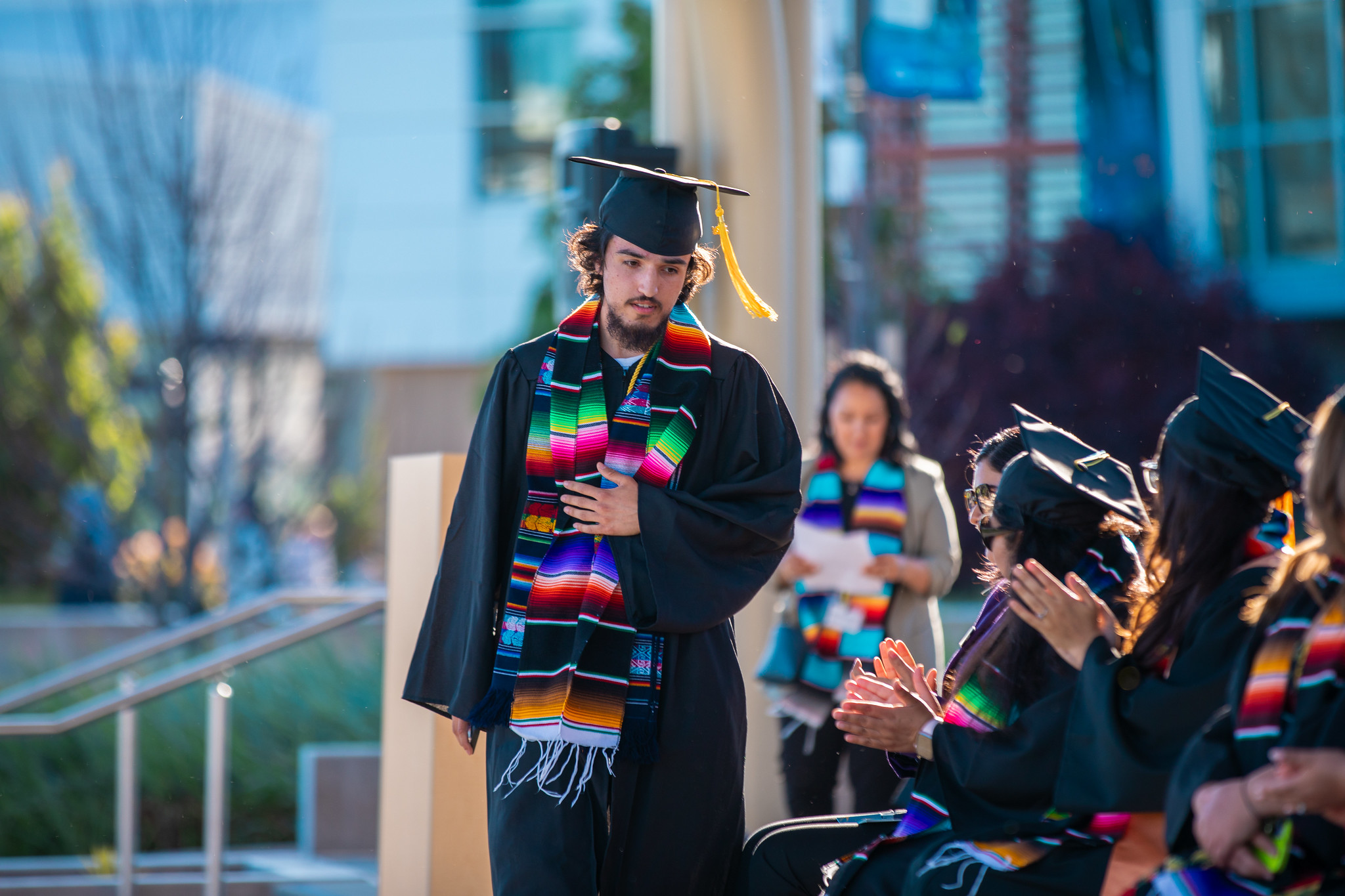 Mission College Puente member graduate walking