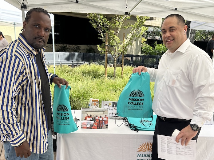 Jared So'oto in white shirt, black slacks at table during event for Hospitality on Mission College campus.