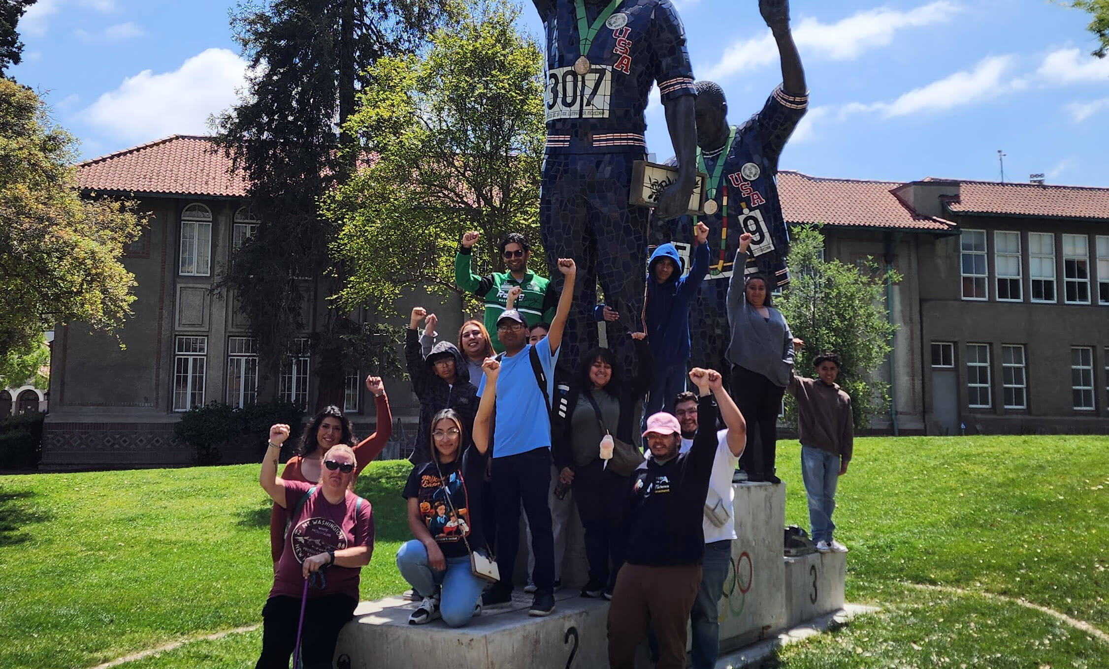TRIO Students posing for picture next to monument