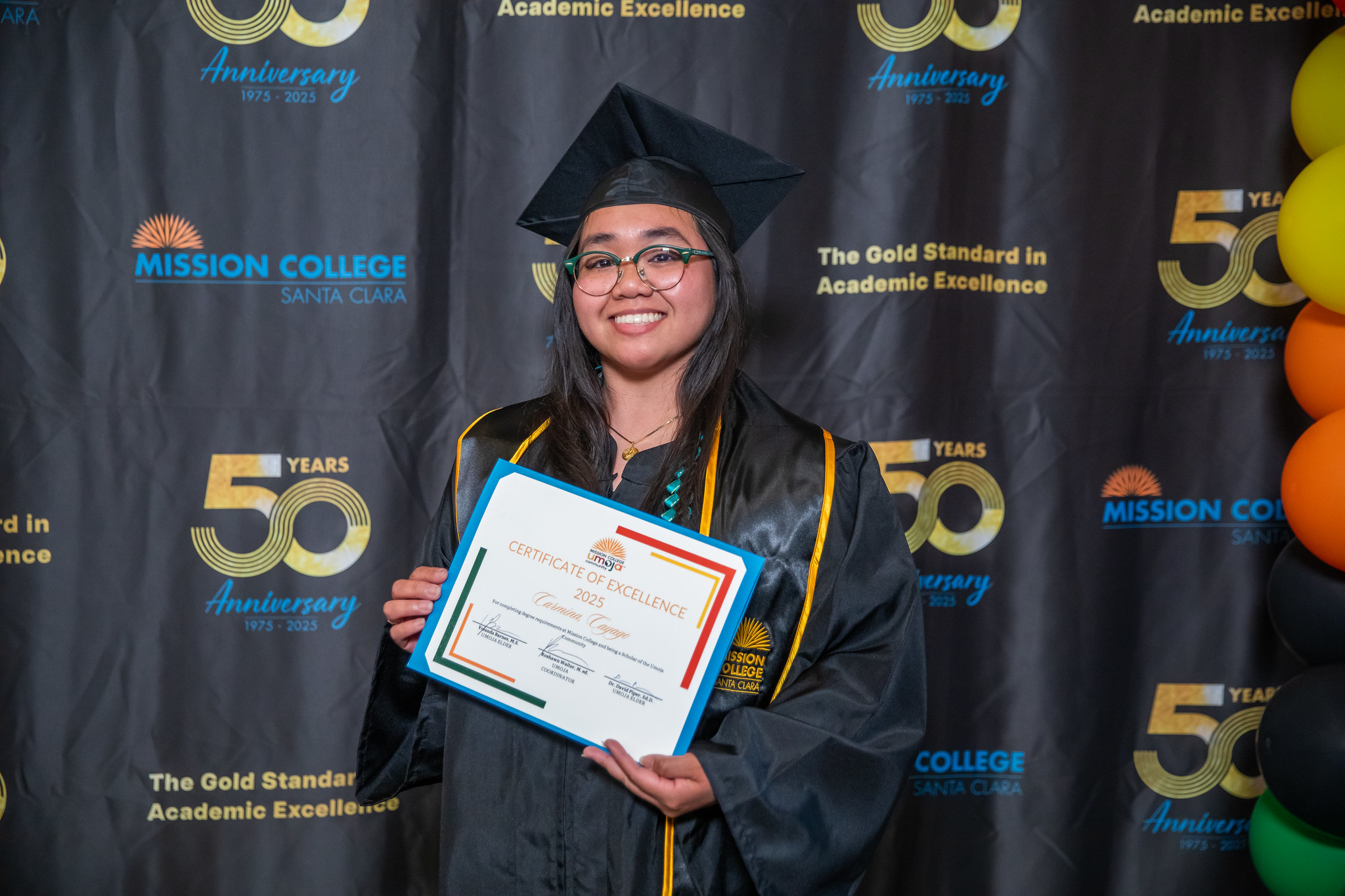 Umoja grad smiling holding certificate
