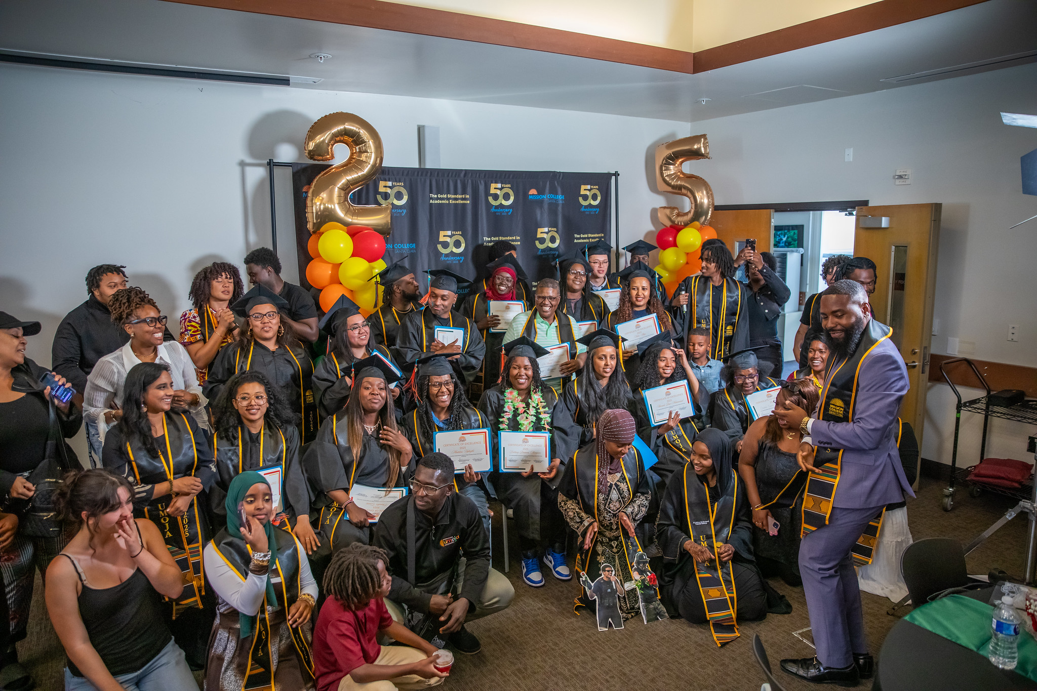 Umoja grads posing for group picture